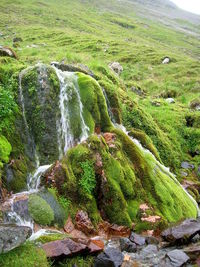 Scenic view of waterfall against sky