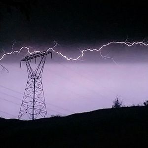 Low angle view of power lines against sky