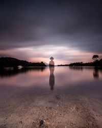 Scenic view of lake against cloudy sky