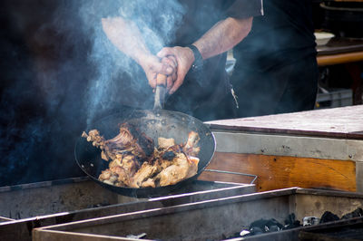 Man preparing food on barbecue grill