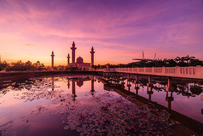 View of lake at temple against sky during sunset