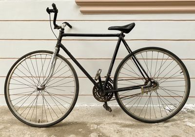 Bicycle parked against wall