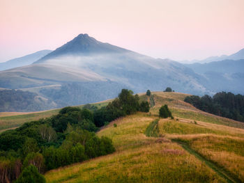 Scenic view of landscape and mountains against sky