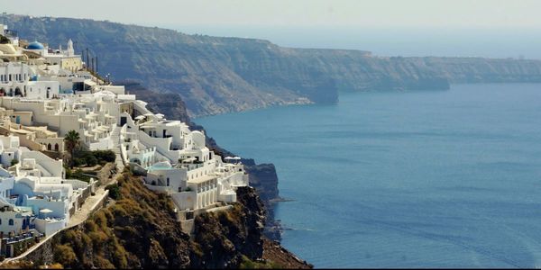 High angle view of buildings by sea against sky