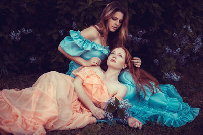 High angle view of young women sitting on grass