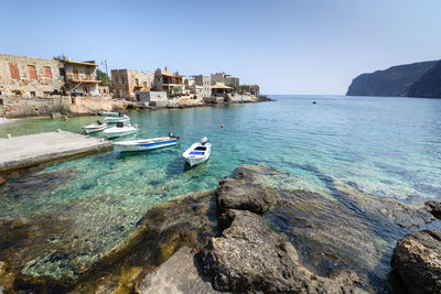 Boats moored on sea