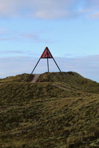 Lifeguard hut on land against sky