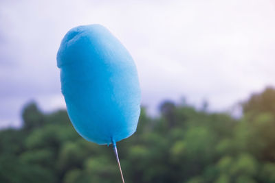 Close-up of balloons against blue sky