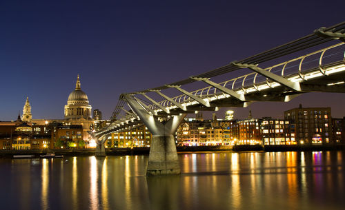 Illuminated buildings against sky at night