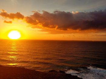 Scenic view of sea against romantic sky at sunset