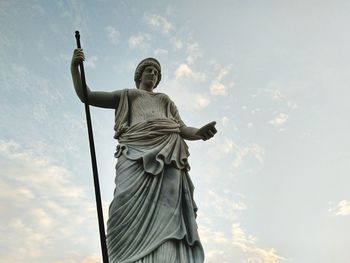 Low angle view of female sculpture against sky