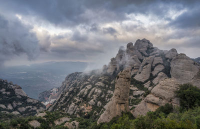 Scenic view of mountain against cloudy sky