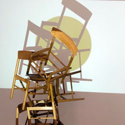 Low angle view of empty chair on table against clear sky