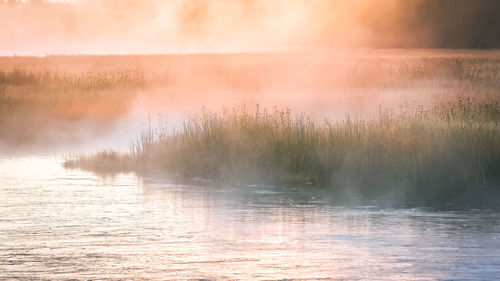 Scenic view of lake against sky during sunset