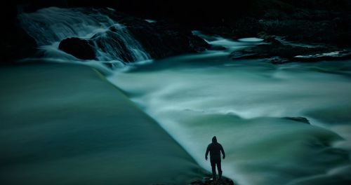 Man surfing on rock in sea