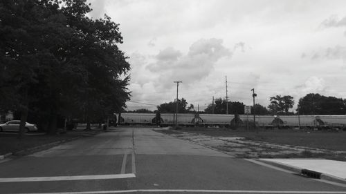 Empty road against cloudy sky