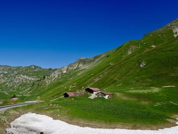 Scenic view of green landscape against blue sky