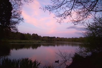 Scenic view of lake against sky at sunset