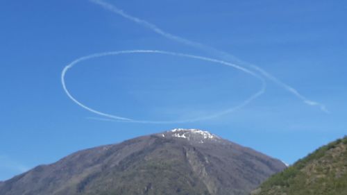 Low angle view of mountain against blue sky