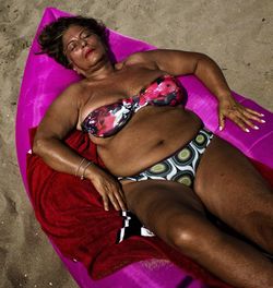 High angle view of woman lying on sofa