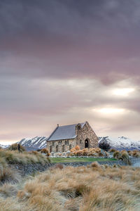 Sunrise view of the church of good shepherd with beautiful snow capped mountain range. 