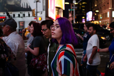 People on street in city at night