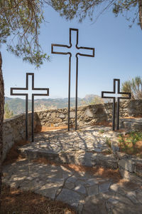 Cross in temple against sky