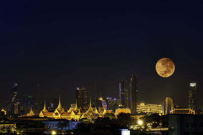 Cityscape of night view with super moon. night view in the business location. bangkok, thailand