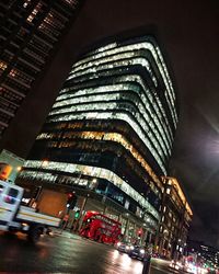 Low angle view of illuminated skyscraper against sky at night