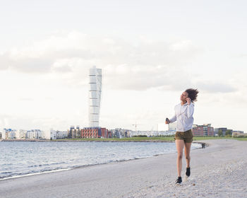 Young woman running at sea