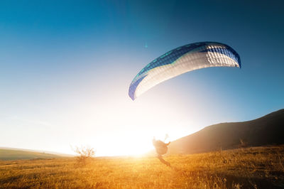 Launching a speedwing from a mountain. a paraglider is preparing to take off from a mountain