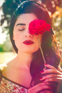 Close-up of young woman with flowers