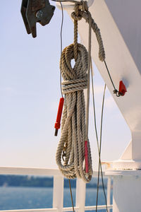 Rope tied to bollard against sky