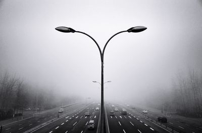 Street light on road against sky