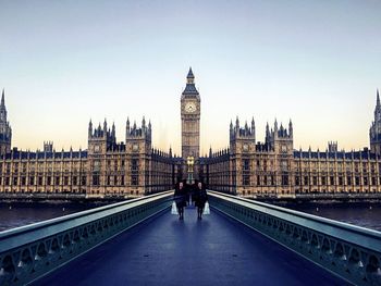 People walking on westminster bridge against clear sky