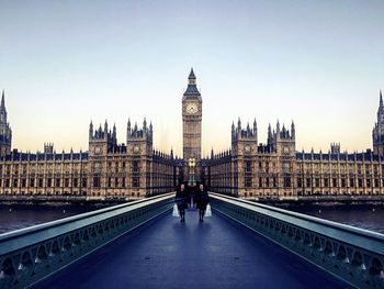 People walking on westminster bridge against clear sky