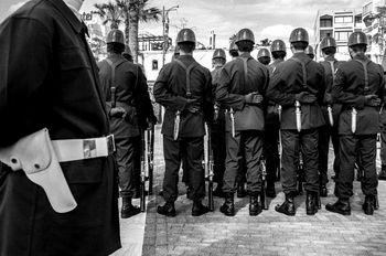 Rear view of army soldiers on street during parade