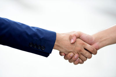 Close-up of human hand against white background