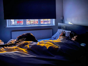 Man sleeping on bed at home
