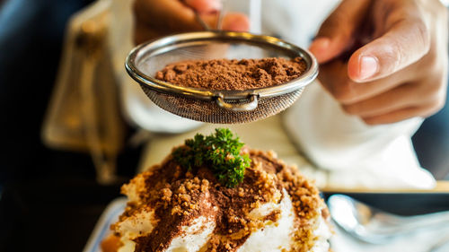 Close-up of hand holding ice cream