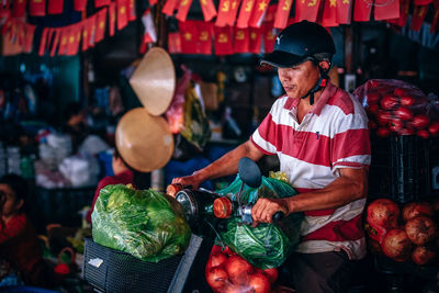 Midsection of man for sale at market stall