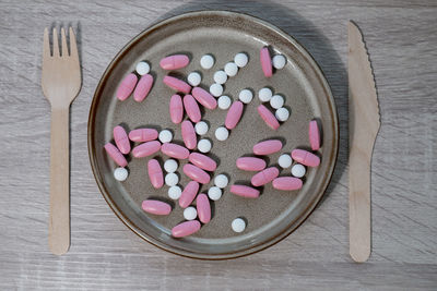 High angle view of pills in bowl on table