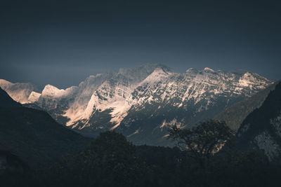 Scenic view of snowcapped mountains against clear sky