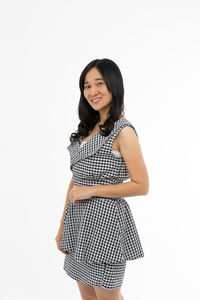 Portrait of a smiling young woman against white background