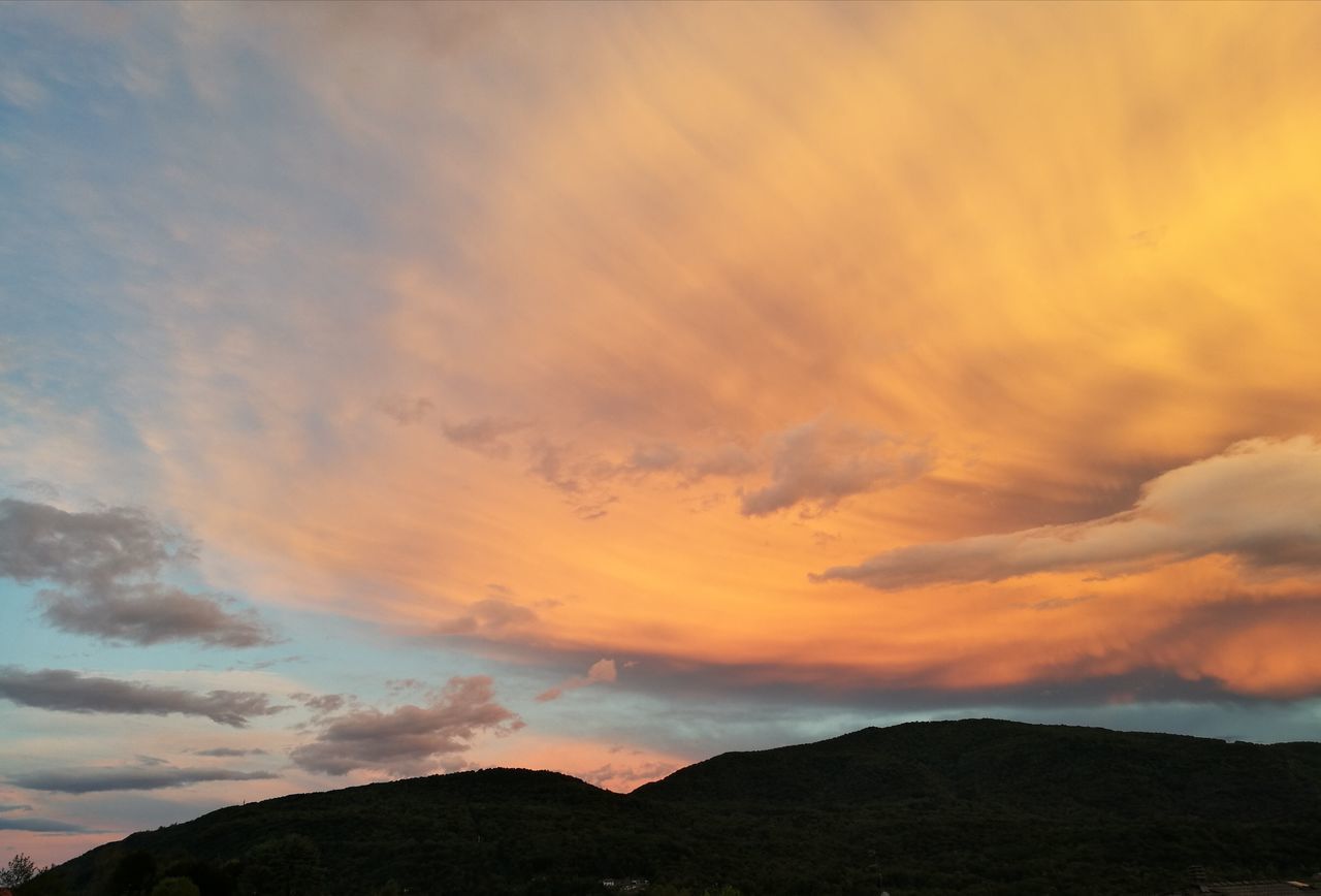 cloud - sky, sky, beauty in nature, scenics - nature, sunset, tranquil scene, tranquility, mountain, non-urban scene, orange color, idyllic, nature, no people, silhouette, environment, outdoors, mountain range, remote, dramatic sky, low angle view, mountain peak