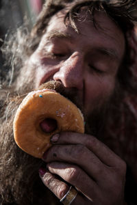 Close-up of man eating donut