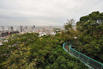 High angle view of trees and buildings against sky