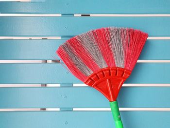 Cobweb broom on blue wall. household equipment concept