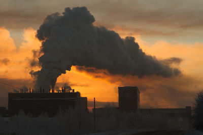 Smoke emitting from chimney against sky during sunset