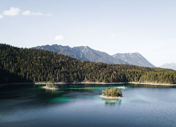 Scenic view of lake and mountains against sky